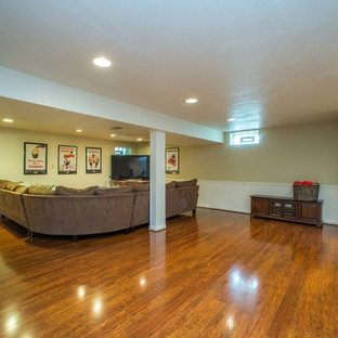 Photo of a large classic look-out basement in Other with beige walls, dark hardwood flooring and brown floors.