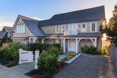 Elegant gray three-story wood and shingle exterior home photo in Portland with a shingle roof and a gray roof