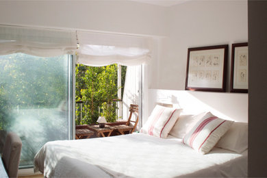 Foto de dormitorio contemporáneo de tamaño medio con paredes blancas, suelo de madera en tonos medios y suelo marrón