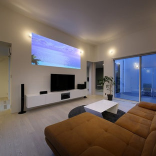 This is an example of a modern open plan home cinema in Other with white walls, plywood flooring, a projector screen and white floors.