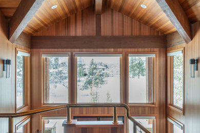 Example of a huge mountain style slate floor, black floor, wood ceiling and wood wall entryway design in Portland