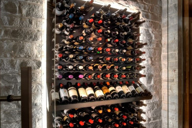Small contemporary wine cellar in Los Angeles with medium hardwood floors and display racks.
