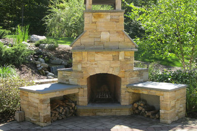 Patio - huge craftsman backyard brick patio idea in Burlington with a fire pit and no cover