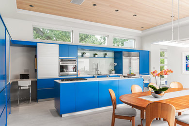 Inspiration for a large contemporary u-shaped eat-in kitchen in Vancouver with a double-bowl sink, flat-panel cabinets, blue cabinets, laminate benchtops, white splashback, glass sheet splashback, stainless steel appliances, ceramic floors and with island.