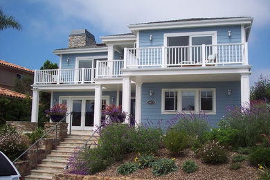 Mid-sized elegant blue two-story concrete exterior home photo in San Diego