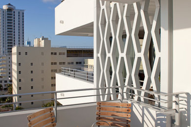 Balcony - contemporary apartment balcony idea in Miami with a roof extension