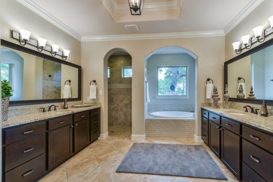 Bathroom - large traditional master beige tile and ceramic tile ceramic tile bathroom idea in Austin with recessed-panel cabinets, dark wood cabinets, beige walls, an undermount sink and granite countertops