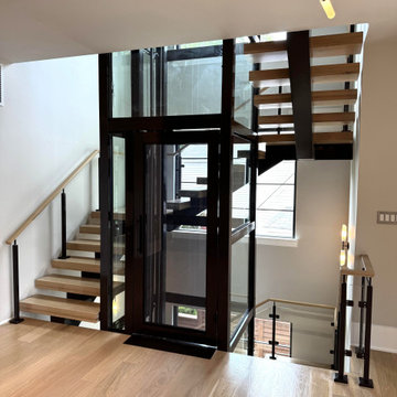 Project #136 | Modern Floating Staircase Encircling Glass Elevator