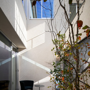 大阪の小さいモダンスタイルのおしゃれな中庭のテラス (タイル敷き、張り出し屋根) の写真