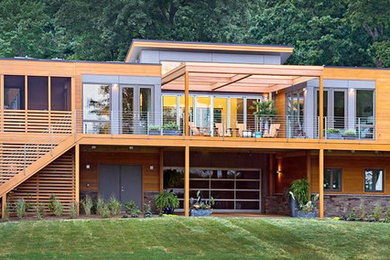 Example of a huge trendy brown two-story wood flat roof design in Las Vegas