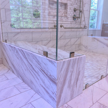 Primary Bathroom with Double Shower and Natural Stone Baseboards