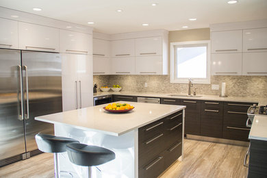Eat-in kitchen - mid-sized contemporary u-shaped eat-in kitchen idea in Other with an undermount sink, flat-panel cabinets, white cabinets, quartz countertops, stainless steel appliances and an island