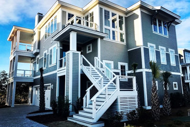 Large beach style gray three-story wood exterior home photo in Wilmington