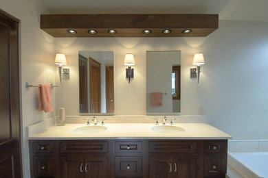 Bathroom - contemporary beige tile and stone tile bathroom idea in Other with an undermount sink, recessed-panel cabinets, dark wood cabinets, marble countertops and a two-piece toilet