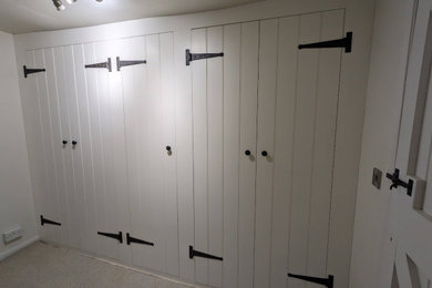 This is an example of a classic wardrobe in Buckinghamshire with white cabinets.