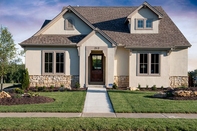 Mid-sized arts and crafts beige two-story stucco gable roof photo in Kansas City