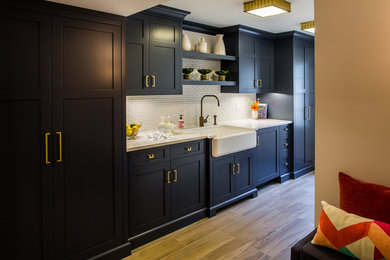 Kitchen - mid-sized farmhouse porcelain tile and brown floor kitchen idea in New York with a farmhouse sink, shaker cabinets, black cabinets, quartz countertops, white backsplash and matchstick tile backsplash