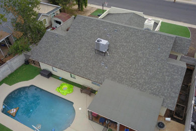 Inspiration for a mid-sized transitional beige one-story exterior home remodel in Phoenix with a shingle roof