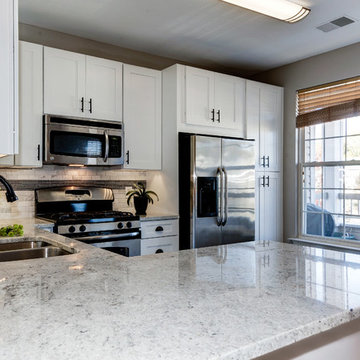 White Kitchen Remodel with Colonial White Granite and Stainless Steel Appliances