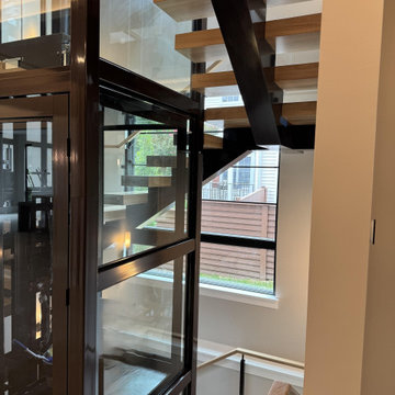 Project #136 | Modern Floating Staircase Encircling Glass Elevator
