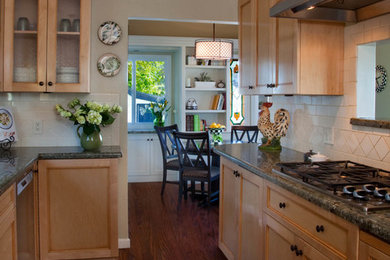 Small elegant galley medium tone wood floor kitchen photo in San Diego with a double-bowl sink, recessed-panel cabinets, light wood cabinets, granite countertops, white backsplash, ceramic backsplash, stainless steel appliances and no island