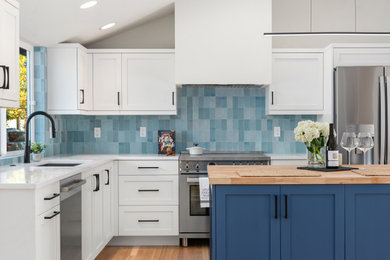 Inspiration for a mid-sized 1950s l-shaped medium tone wood floor, brown floor and vaulted ceiling open concept kitchen remodel in Seattle with an undermount sink, shaker cabinets, blue cabinets, wood countertops, blue backsplash, ceramic backsplash, stainless steel appliances, an island and white countertops