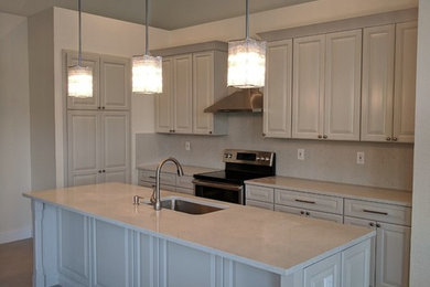Inspiration for a mid-sized transitional u-shaped porcelain tile and gray floor eat-in kitchen remodel in Miami with an undermount sink, shaker cabinets, beige cabinets, quartz countertops, white backsplash, stone slab backsplash, stainless steel appliances, an island and white countertops
