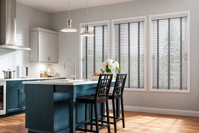 Inspiration for a mid-sized modern galley medium tone wood floor eat-in kitchen remodel in Other with a single-bowl sink, shaker cabinets, blue cabinets, marble countertops, gray backsplash, stainless steel appliances and an island