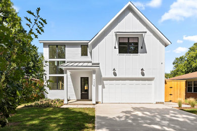 Inspiration for a large farmhouse white two-story mixed siding and board and batten exterior home remodel in Dallas with a shingle roof and a black roof
