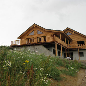Cedar half log siding with cedar deck and railing