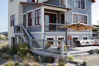This is an example of a beach style three-storey exterior in Seattle with mixed siding.
