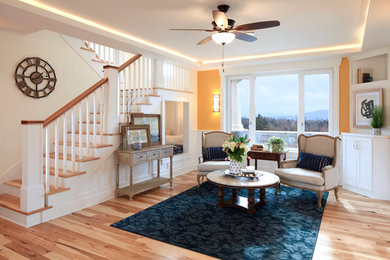 Mid-sized elegant open concept medium tone wood floor living room photo in Other with yellow walls and no fireplace