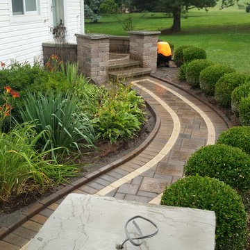 Raised Patio in Wixom with columns and lighting