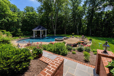 Photo of a mid-sized traditional backyard custom-shaped lap pool in Baltimore with a hot tub and concrete slab.