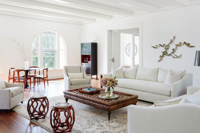Inspiration for a classic living room with white walls, medium hardwood flooring and exposed beams.