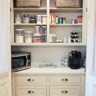 Transitional kitchen pantry inspiration - Inspiration for a transitional light wood floor kitchen pantry remodel in Birmingham with a farmhouse sink, flat-panel cabinets, beige cabinets, marble countertops, white backsplash, subway tile backsplash, paneled appliances and an island