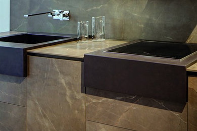 Mid-sized minimalist porcelain tile eat-in kitchen photo in Atlanta with an integrated sink and stone slab backsplash