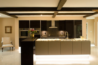 Example of a large eclectic single-wall terrazzo floor and beige floor open concept kitchen design in Miami with an undermount sink, flat-panel cabinets, brown cabinets, brown backsplash, marble backsplash, stainless steel appliances, an island and multicolored countertops