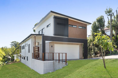 Design ideas for a large modern two-storey brown house exterior in Brisbane with board and batten siding.