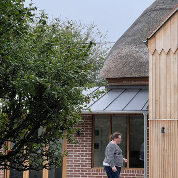 Thatch, oak, zinc and brick