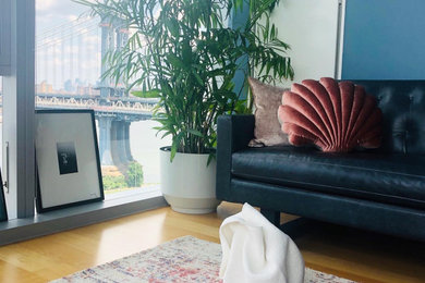 Example of a mid-sized eclectic open concept living room design in New York with blue walls