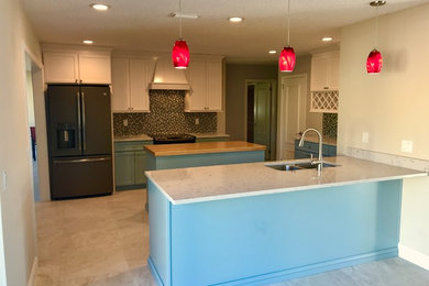 Mid-sized beach style u-shaped eat-in kitchen photo in Orlando with shaker cabinets, turquoise cabinets and two islands