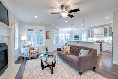 Inspiration for a craftsman open concept dark wood floor living room remodel in Raleigh with gray walls, a standard fireplace, a tile fireplace and a wall-mounted tv