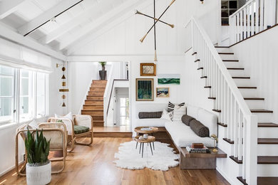 Inspiration for a scandinavian medium tone wood floor and brown floor living room remodel in Orange County with white walls