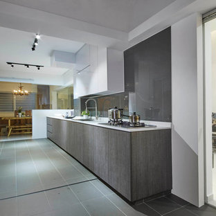 Mid-sized scandinavian kitchen pantry remodeling - Mid-sized danish galley ceramic floor kitchen pantry photo in Singapore with a single-bowl sink, flat-panel cabinets, dark wood cabinets, granite countertops, gray backsplash, glass sheet backsplash, stainless steel appliances and no island
