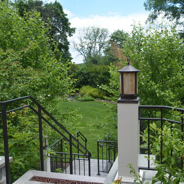 Custom railings and post mount lights. Iron drainage grate.