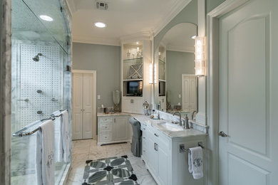 Example of a mid-sized classic master white tile marble floor double shower design in New Orleans with raised-panel cabinets, white cabinets, marble countertops, blue walls and an undermount sink