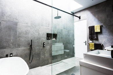 Contemporary master bathroom in Sydney with white cabinets, engineered quartz benchtops, an open shower and cement tile.