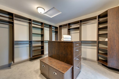 This is an example of a large transitional walk-in wardrobe in Minneapolis.