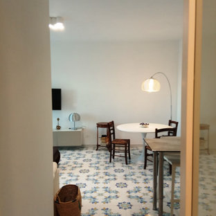 Large tuscan open concept ceramic tile and multicolored floor family room photo in Rome with white walls and a wall-mounted tv